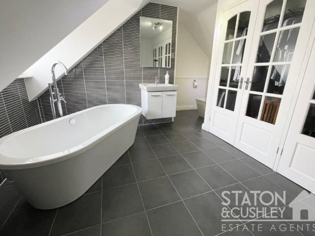 A free-standing bath, with mixer tap, is the highlight of the impressive bathroom on the second floor of the £725,000 property. It also features vanity units with a top-mounted sink, a low-level WC, fitted wardrobes, built-in storage cupboard, tiled floor, part-tiled walls and a heated towel-rail.