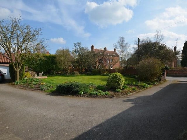 A long driveway leads to a double garage, with electric doors. The garden also features two patio areas, external power and an outside tap.