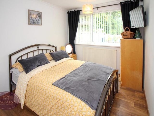 Bedroom number two is another double, with wood-effect, laminate flooring and facing the rear garden