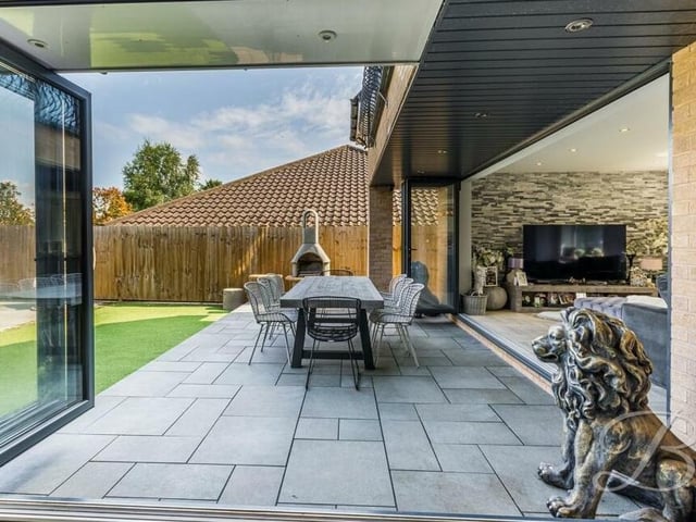 Fling open the bi-folding doors to the sitting room and you could enjoy al fresco meals on this garden patio.