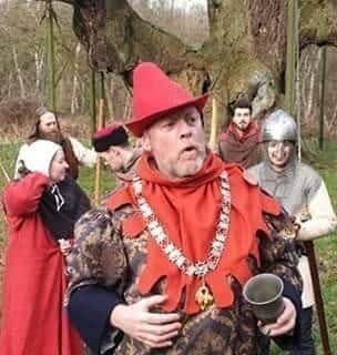 Richard Townsley dressed as The Sheriff of Nottingham pictured by the Major Oak with Robin Hood's outlaws