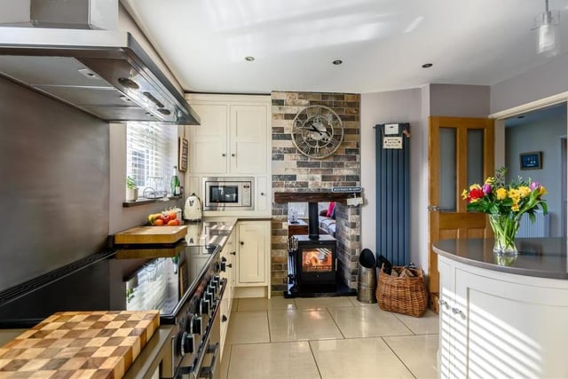 A third shot of the kitchen/breakfast room shows how it is full of character and charm, particularly with its dual log-burner and granite hearth.