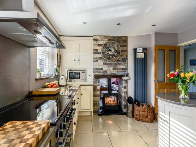 A third shot of the kitchen/breakfast room shows how it is full of character and charm, particularly with its dual log-burner and granite hearth.