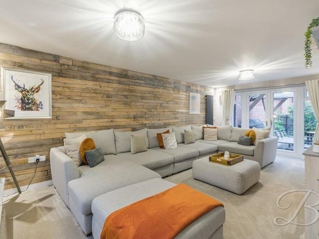 The large living room also features French doors at one end leading outside to the rear garden.