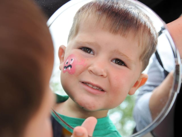 Archie Ansty, 2, checks out his face paint design.