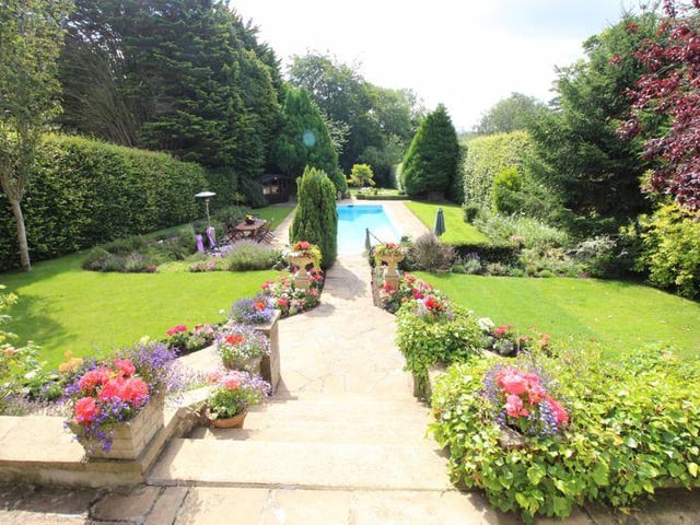 The rear garden, complete with outdoor swimming pool.