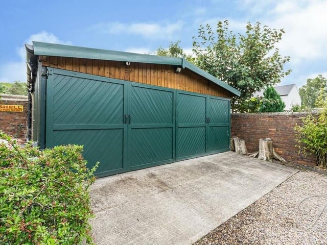 The final photo in our gallery shows the substantial, detached triple garage at the end of the front driveway.