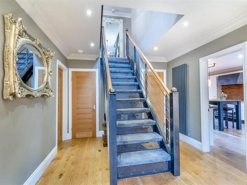 The entrance hall really has the wow factor with vertical radiator, oak floor, six ceiling spotlights, coving to ceiling, two double glazed windows to the front elevation, built-in cloaks/shoe cupboard and central galvanised steel staircase rising up to the first floor galleried landing.