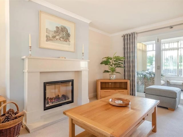 A delightful reception room enjoying a triple aspect. There is a marble fireplace with inset remote controlled gas fire, two radiators, coving to ceiling, three wall light points, double glazed windows to the front and side elevations, and contemporary double glazed bi-folding doors provides access through to the garden room.