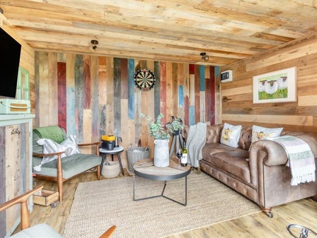 A peek inside the garden room reveals a relaxing retreat, with a wood floor, an electric streamline radiator, power points and a ceiling made of reclaimed solid wood.