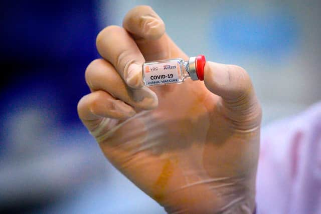 laboratory technician holding a dose of a COVID-19 novel coronavirus vaccine candidate (Photo by Mladen ANTONOV / AFP) (Photo by MLADEN ANTONOV/AFP via Getty Images)