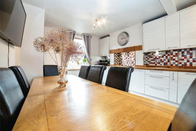 The kitchen has plenty of space for a dining table. There is also a single drainer sink unit with mixer taps, a tiled floor, splashbacks and windows to the front and back of the house. A nearby utility room has space for a washing machine.
