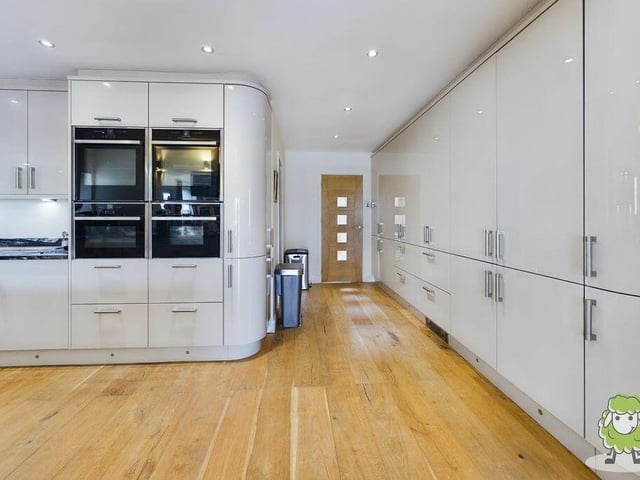 The contemporary kitchen is fully equipped and handsomely presented.