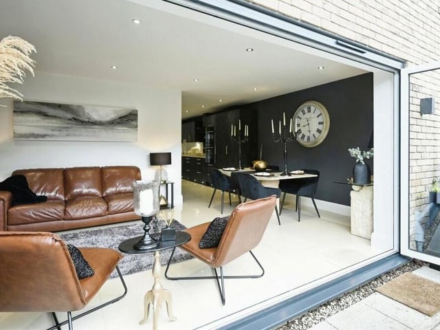 Once the bi-folding doors of the lounge and dining area, this is the view. In the background, you can see how the open-plan space extends into the kitchen.