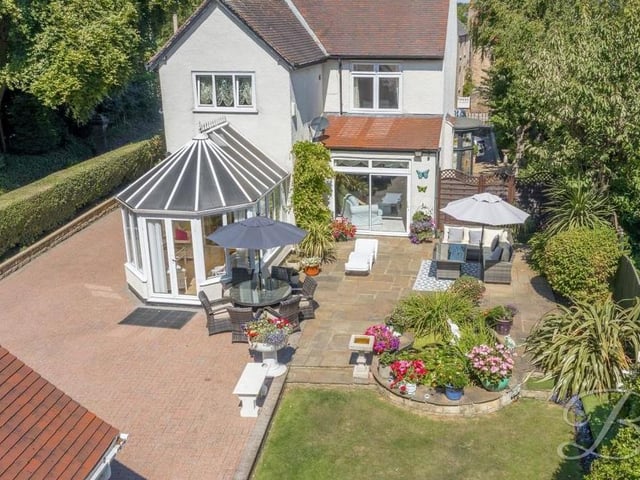 This second drone shot shows how the £575,000 house looks from the rear. You can see the conservatory, the sliding doors that lead from the open-plan living room, a patio, part of the garden and part of the driveway that provides off-street parking space.