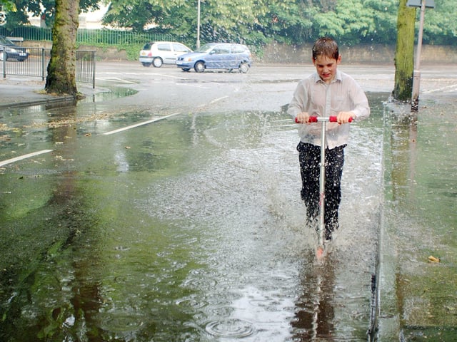 Parts of Mansfield suffered from flooding during particularly heavy rain in 2001. In typical Mansfield style, the rain didn't stop this young man from having fun!