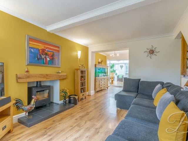 We begin our tour of the £425,000-plus house in the warm and welcoming lounge. The log-burner catches the eye, a does the laminate flooring.