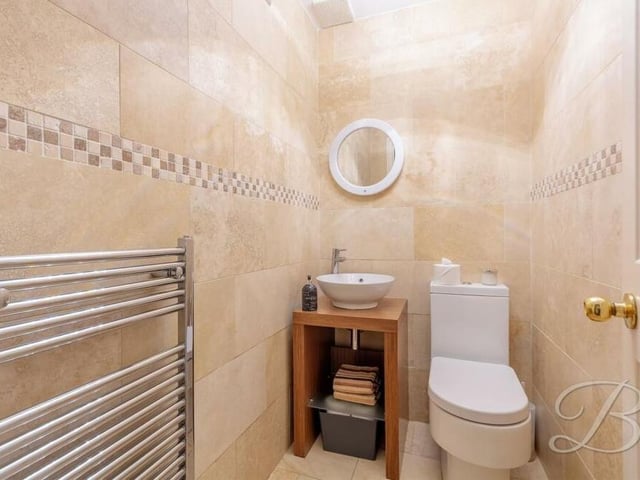 The downstairs toilet is a stylish bonus. It comprises a low-flush WC, hand wash basin, chrome, heated towel-rail and full-height tiling.