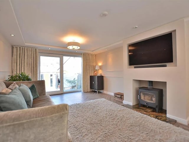 Having a 5kw log burner with granite hearth, karndean flooring, two radiators, recessed lighting with ceiling spotlights, double glazed window to the front elevation and sliding patio door leading out onto the rear garden.