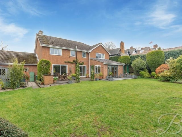 Time now to take a look outside, and here is a view of the back of the £775,000--plus property from the lawned rear garden.
