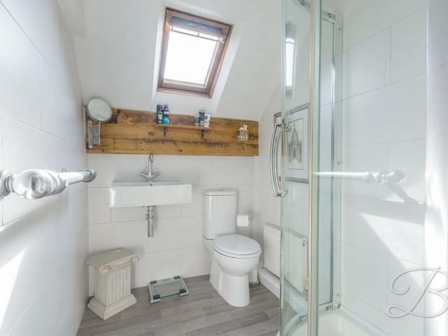 The master bedroom on the first floor has access to this en suite facility. It consists of an enclosed shower, low-flush WC, wash and basin, tiling and Velux window.