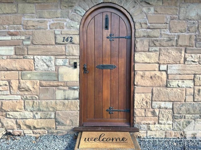 'Welcome!' is the message as we knock on the distinctive, arch feature front door.