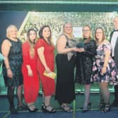 Left, Janet Archer and staff from Specsavers presenting award winners with the Professional Services Award in 2019, far right award host Sarah Julian