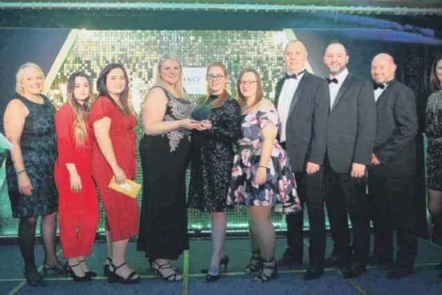 Left, Janet Archer and staff from Specsavers presenting award winners with the Professional Services Award in 2019, far right award host Sarah Julian
