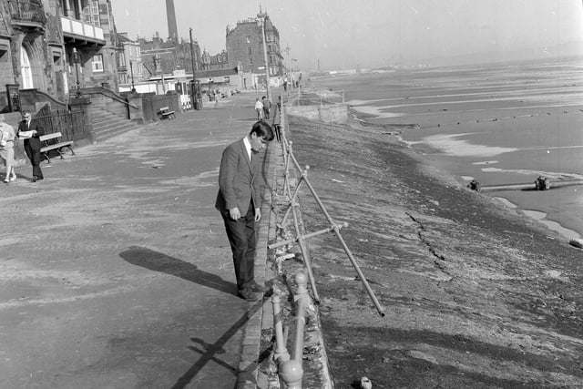 Checking out the damage done to the Portobello promenade after storms in January 1965.