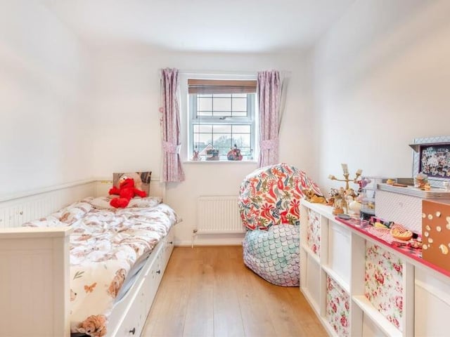 Bedroom number two, which faces the front of the house, features fitted wardrobes, with hanging rails and shelving, and also a laminate floor.