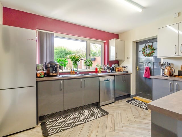The recently-fitted kitchen is contemporary in looks and functionality. It has a comprehensive range of modern, high-gloss cabinets, comprising wall cupboards, base units and drawers, with worktops and an inset one-and-a-half-bowl sink with filtered mixer tap. There is space for a large fridge/freezer.