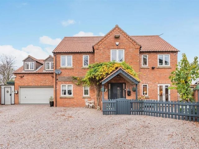 The exclusive property is one of only five detached dwellings positioned at the end of a shared private road off Forest Road, set back behind double gates with a large gravel driveway flanked by brick walls and modern fenced boundaries leading to an integral 1 1⁄2 double garage.