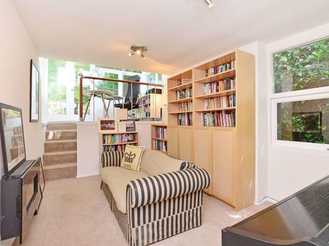 Well-presented with a small flight of stairs leading to a mezzanine home office, with glazed windows to four sides.