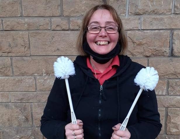 Mourners at Edmund (Eddy) Horne's funeral will pay tribute with a toilet brush salute. Pictured is 'Sam' of the Mansfield Woodhouse Farm Foods shop where toilet brushes can be collected on the day of the funeral.