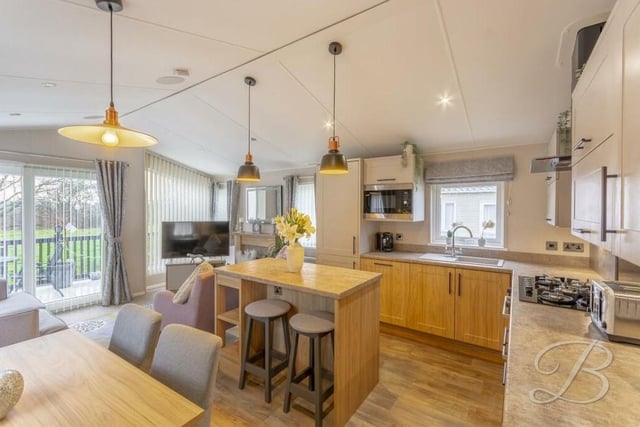 The hub of the home is this open-plan kitchen/dining room, which includes sliding doors that lead out to the front of the property.