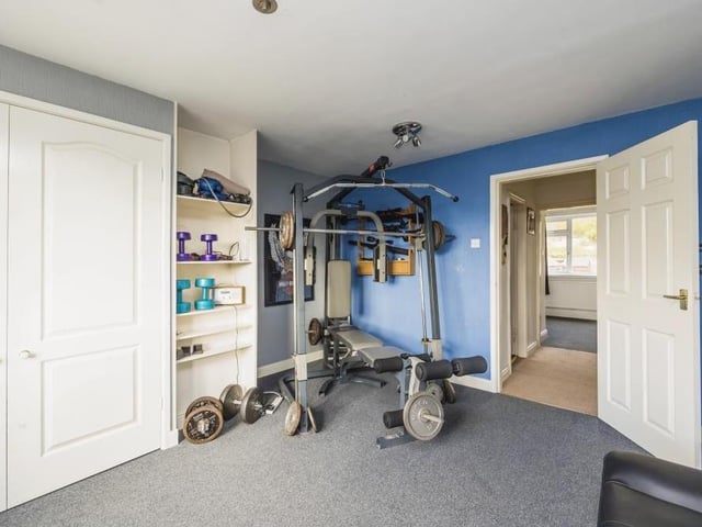 This second bedroom is so flexible that it has been turned into a mini-gym. It boasts plenty of storage space too.