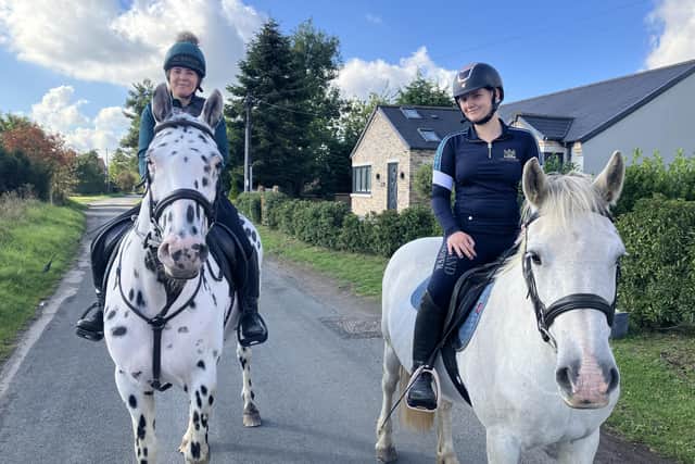 Anita on her horse Sully, with her daughter Alyssia riding Mara