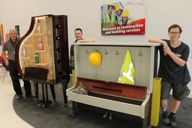 Proudly showing off the drinks cabinet and combined coat rail and boot store made out of vintage pianos are Ian Bradford, Maddie Esswood and Jack Bond.