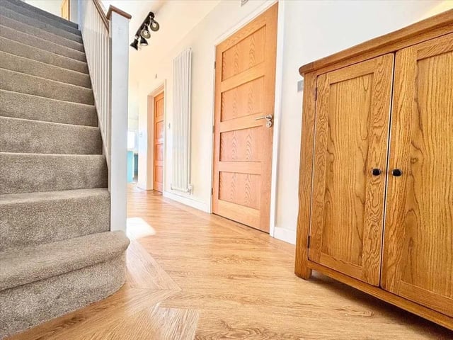 The inviting hallway offers access to the lounge, WC, utility and open plan kitchen.