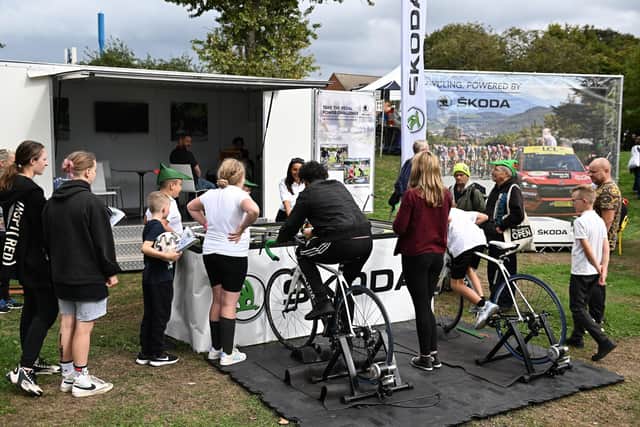 Children take part in Skoda’s pedal power challenge in the Tour village.