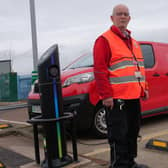 Mansfield Delivery Office postman, Dean Walters, stands alongside one of the new EVs at the site