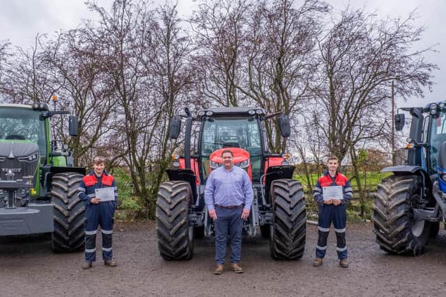 Award winners Frazer Cross, left, and Lewis Woodward, right, with Andrew Walker of B&B Tractors.