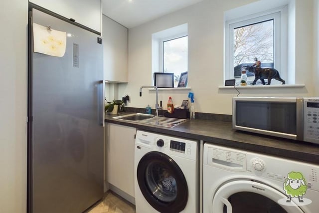 Not far away from the kitchen is this handy utility room, which has space for a washing machine and tumble dryer.