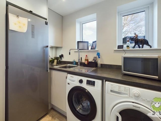 Not far away from the kitchen is this handy utility room, which has space for a washing machine and tumble dryer.