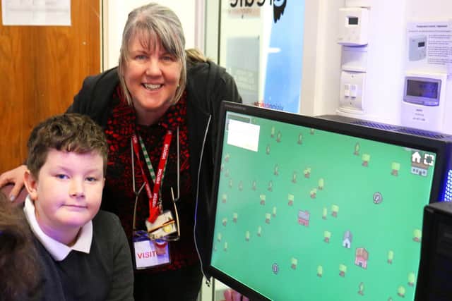 Sutton Road Primary school pupil Riley Lowe with teaching assistant Helen Bearder