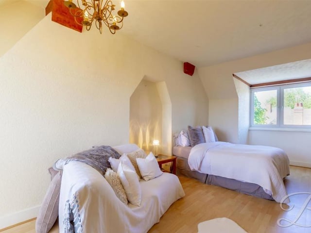 Here is the fourth bedroom, which sits on the third floor. It is a stylish room, with plenty of space, wooden flooring, arched roof, central heating radiator and double-glazed window facing the front of the Layton Avenue property.