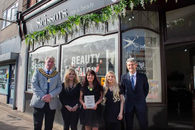 Coun Arnie Hankin, staff at Scissors, Brenda Vincent, owner of Scissors Hair and Beauty, and Trevor Middleton, town centre and markets manager