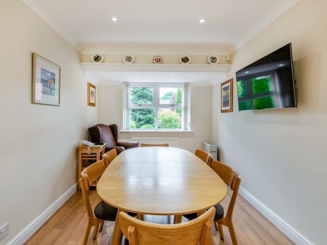 A close-up of the dining or breakfast table area at one end of the open-plan kitchen. The window overlooks the front of the £720,000 house.