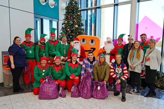 Amazon EMA2 staff present toys and chocolate to Leanne Minett, corporate matron at King's Mill Hospital.