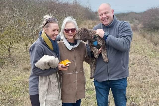 Phil James (right) reuniting a lost dog with its worried owners.